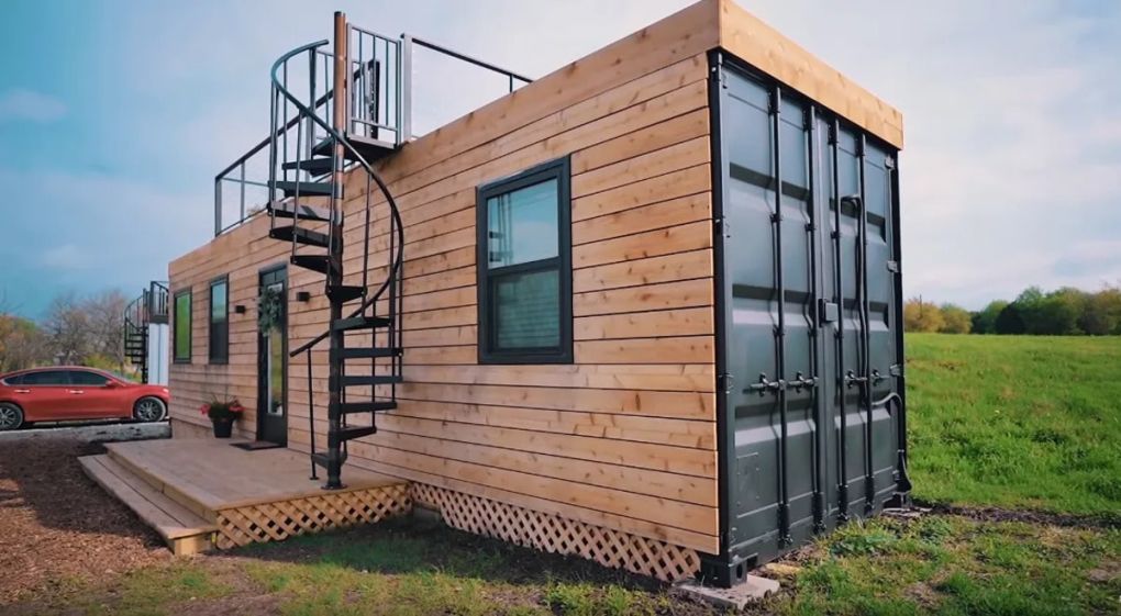 Modern shipping container home with wood slat exterior and black trim